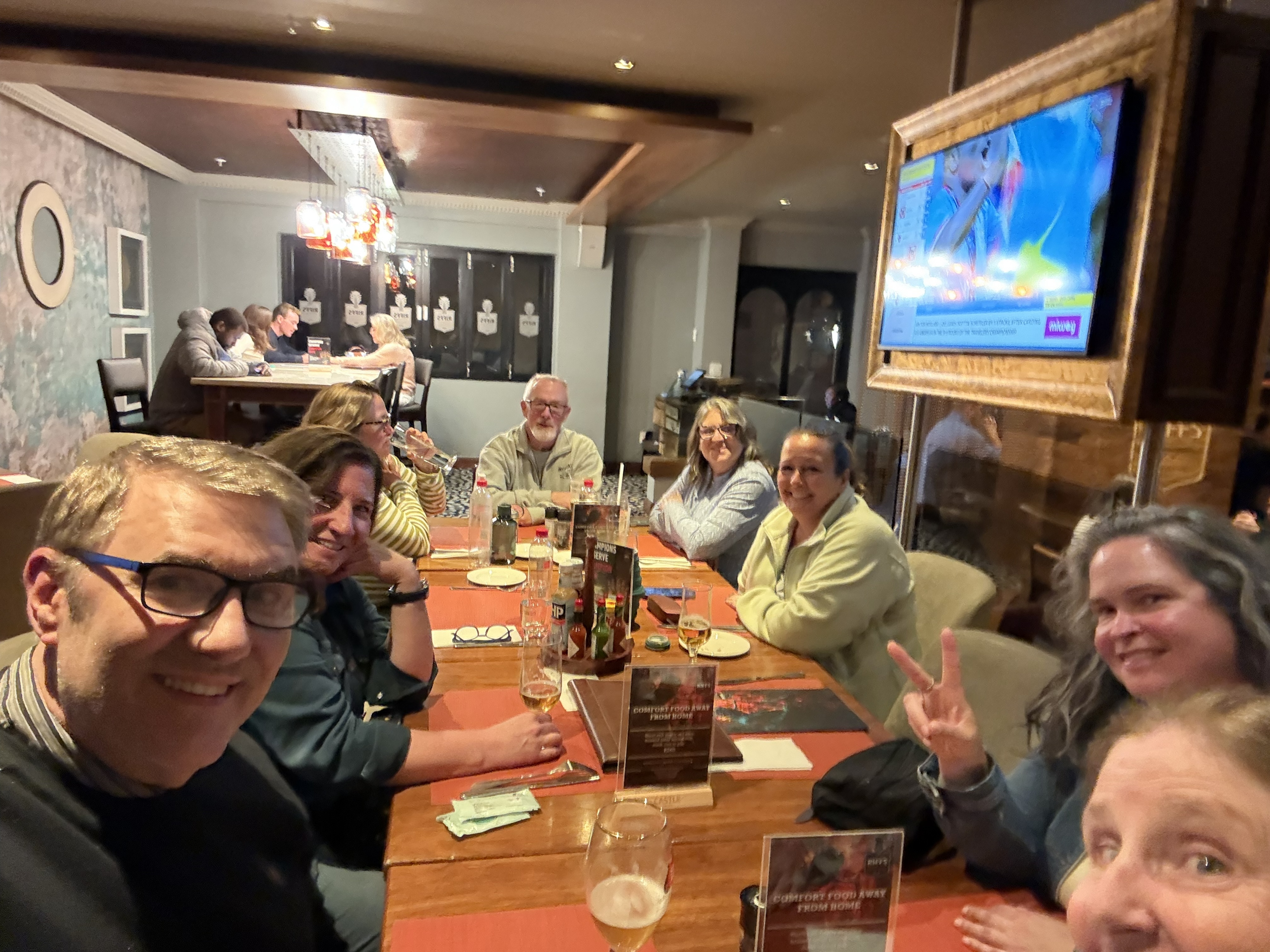 The whole cast, more or less, around one long table. Everyone still politely arranged. Nobody yet knew who snored on a bus, who was always first to the vehicle, who would become th