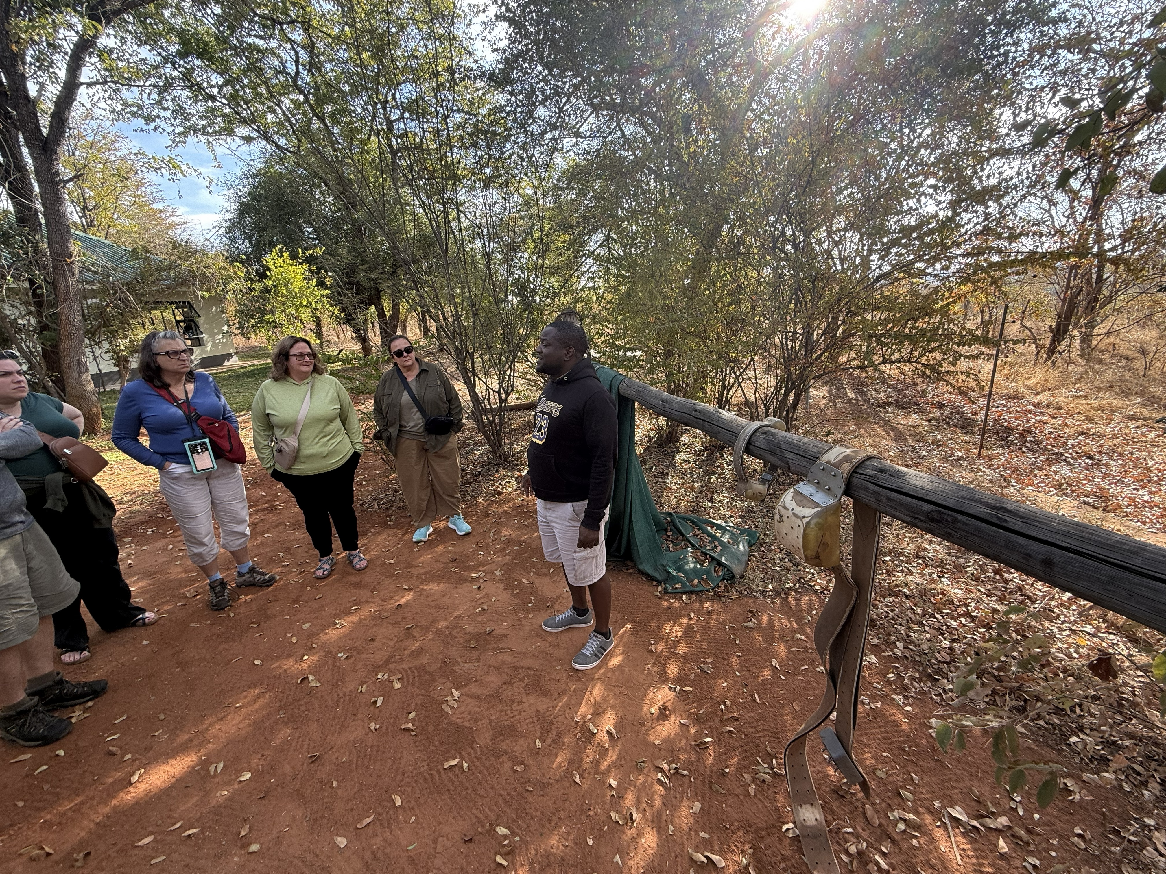 One of the staff showing us the tracking collars, sized by animal — the big one is for an elephant. Somewhere out in the bush, animals are wearing these so that people can know whe