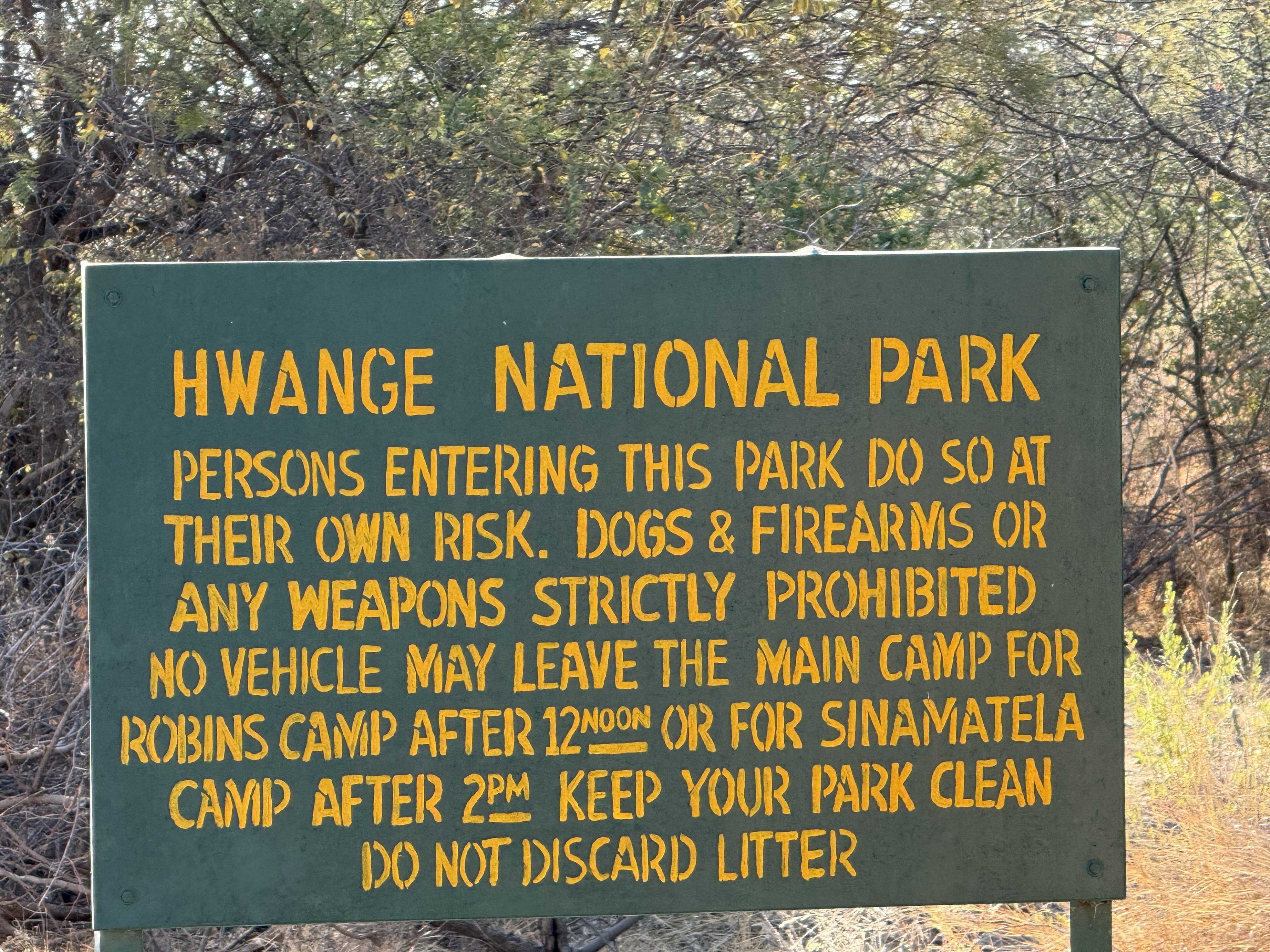 The gate. “Persons entering this park do so at their own risk” — which, in a park with this many lions, is not boilerplate.