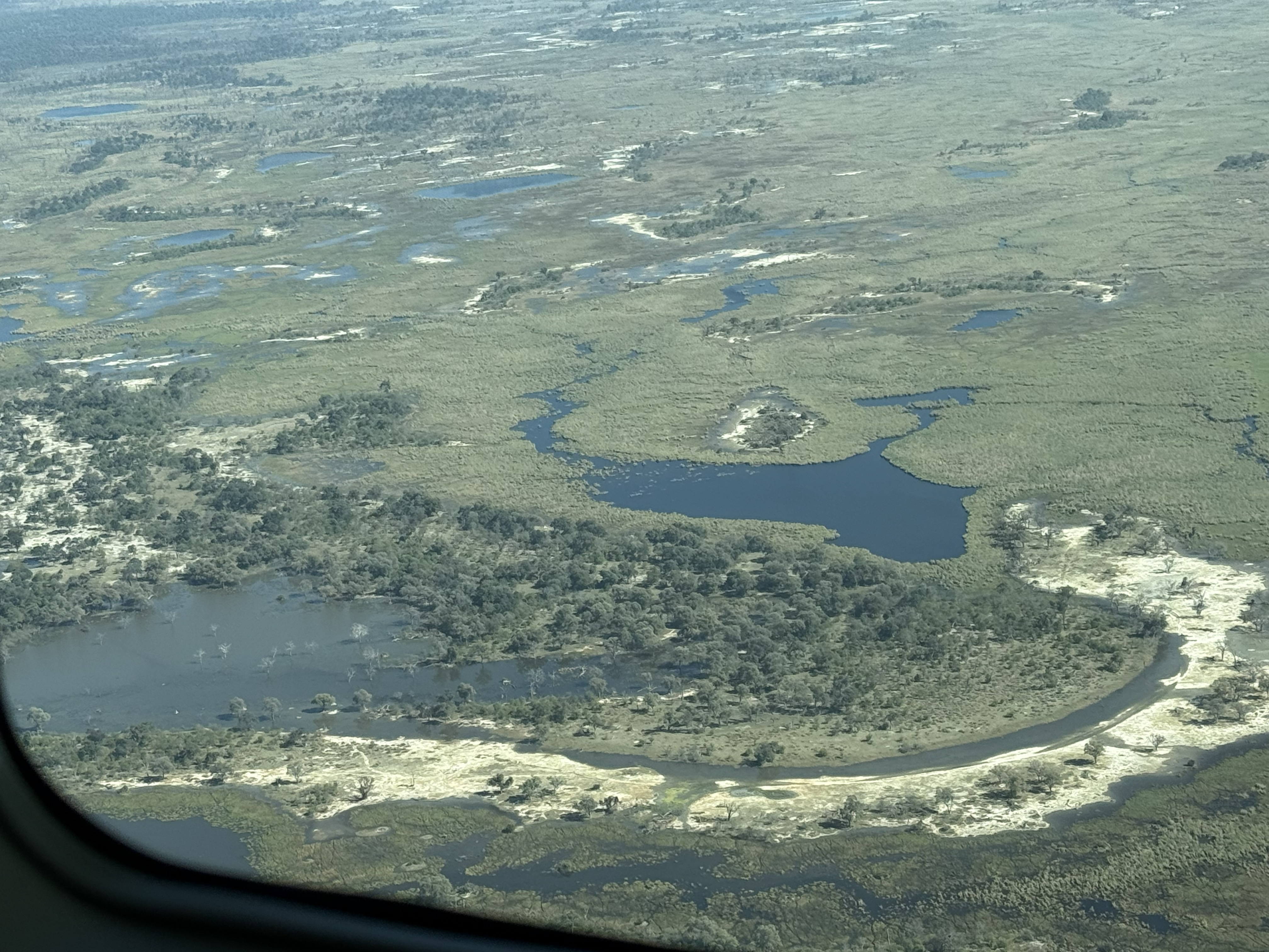 And the thing you can only see from up here: the Delta itself, the whole improbable shape of it — channels and islands and lagoons braided across the sand, a river spending itself