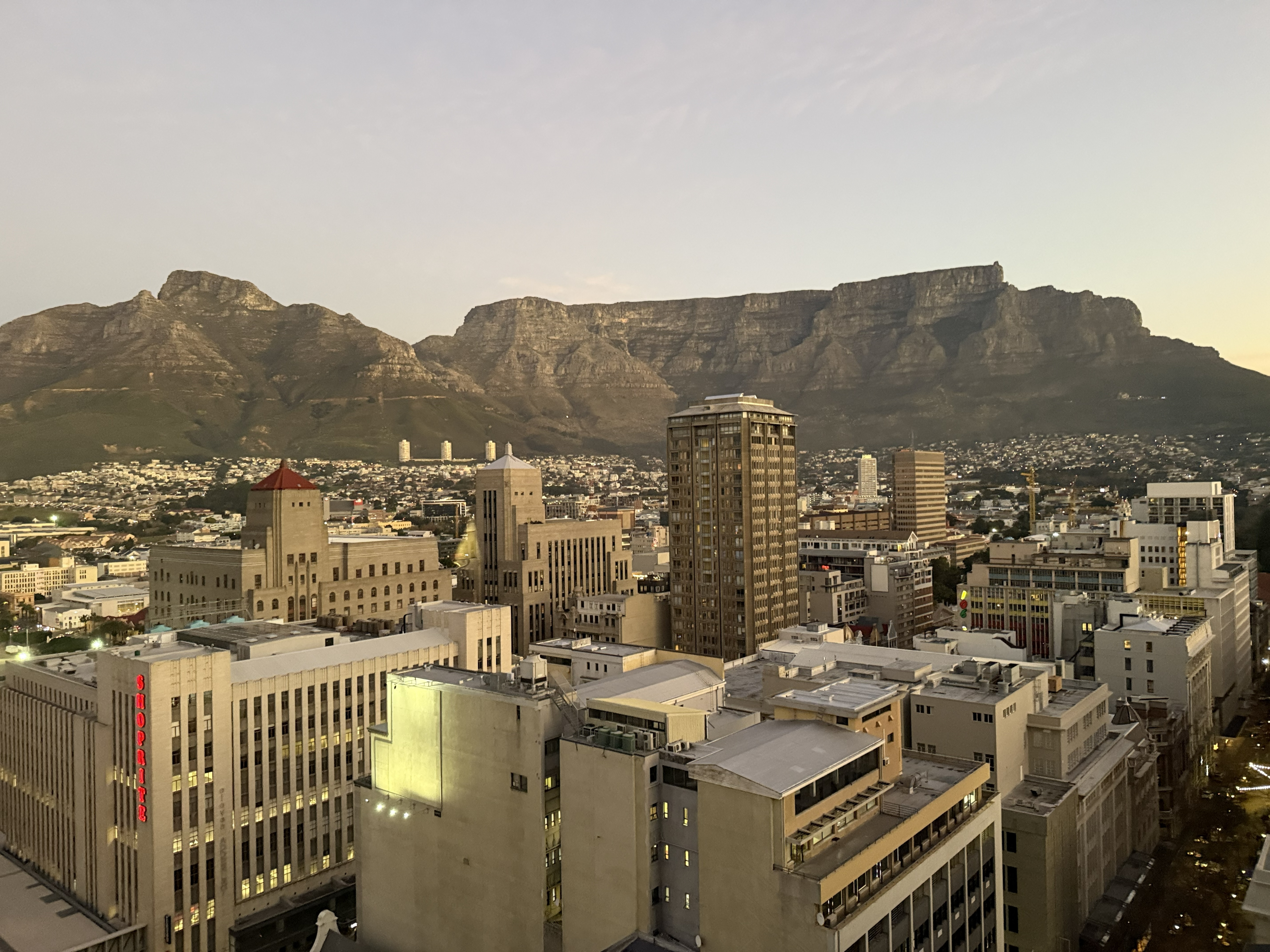 Cape Town at dusk from my window on the twentieth floor, Table Mountain squared off above the city like a wall at the edge of the world. Two weeks ago I was watching elephants at a