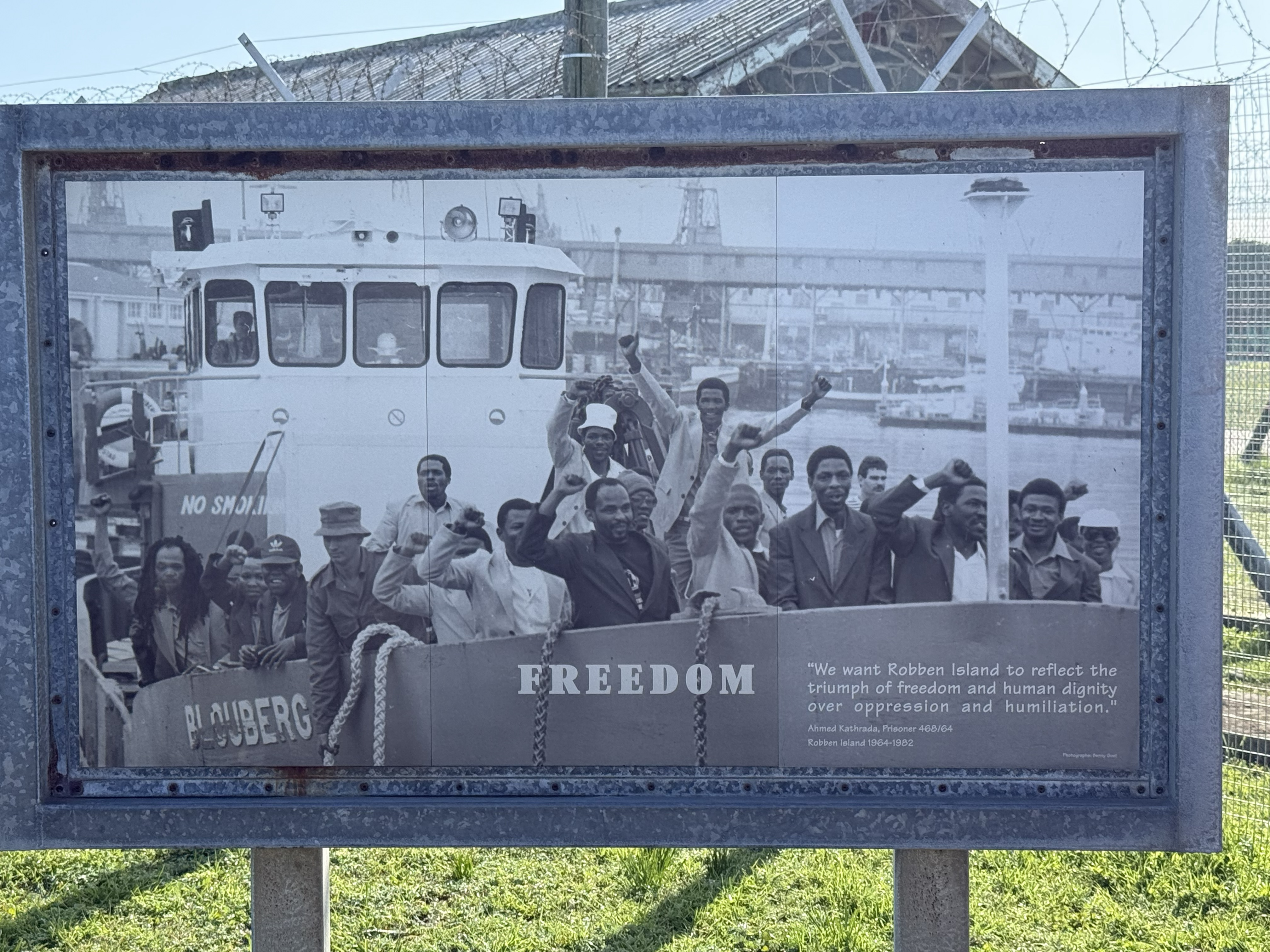 One of the exhibition panels: the history laid out in photographs, the word “FREEDOM” across the bottom, which on Robben Island is not an abstraction but the specific thing that wa