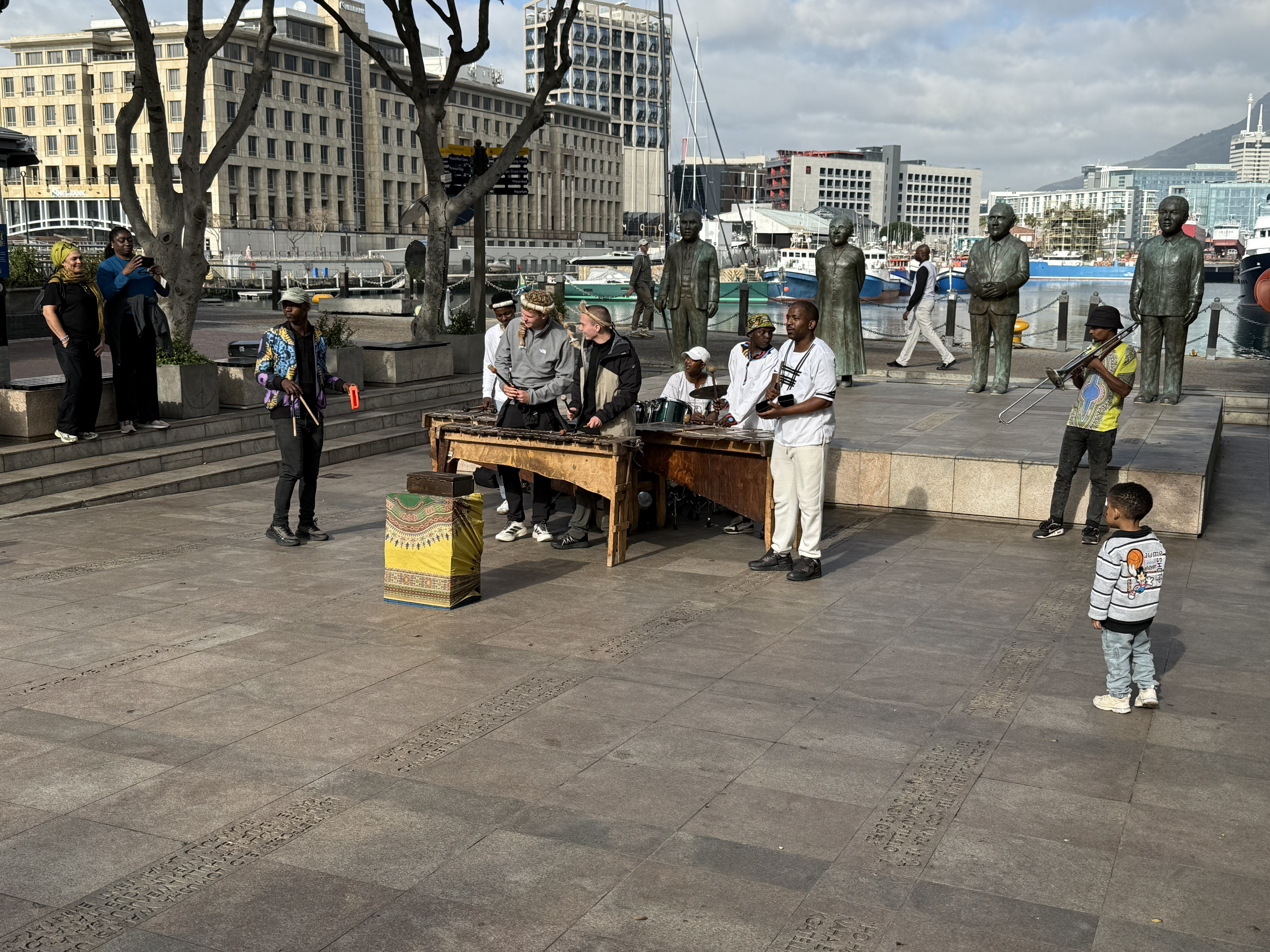 Back at the Waterfront afterward, Nobel Square — four bronze figures standing together: Albert Luthuli, Desmond Tutu, F. W. de Klerk, and Mandela, South Africa's four Nobel Pe