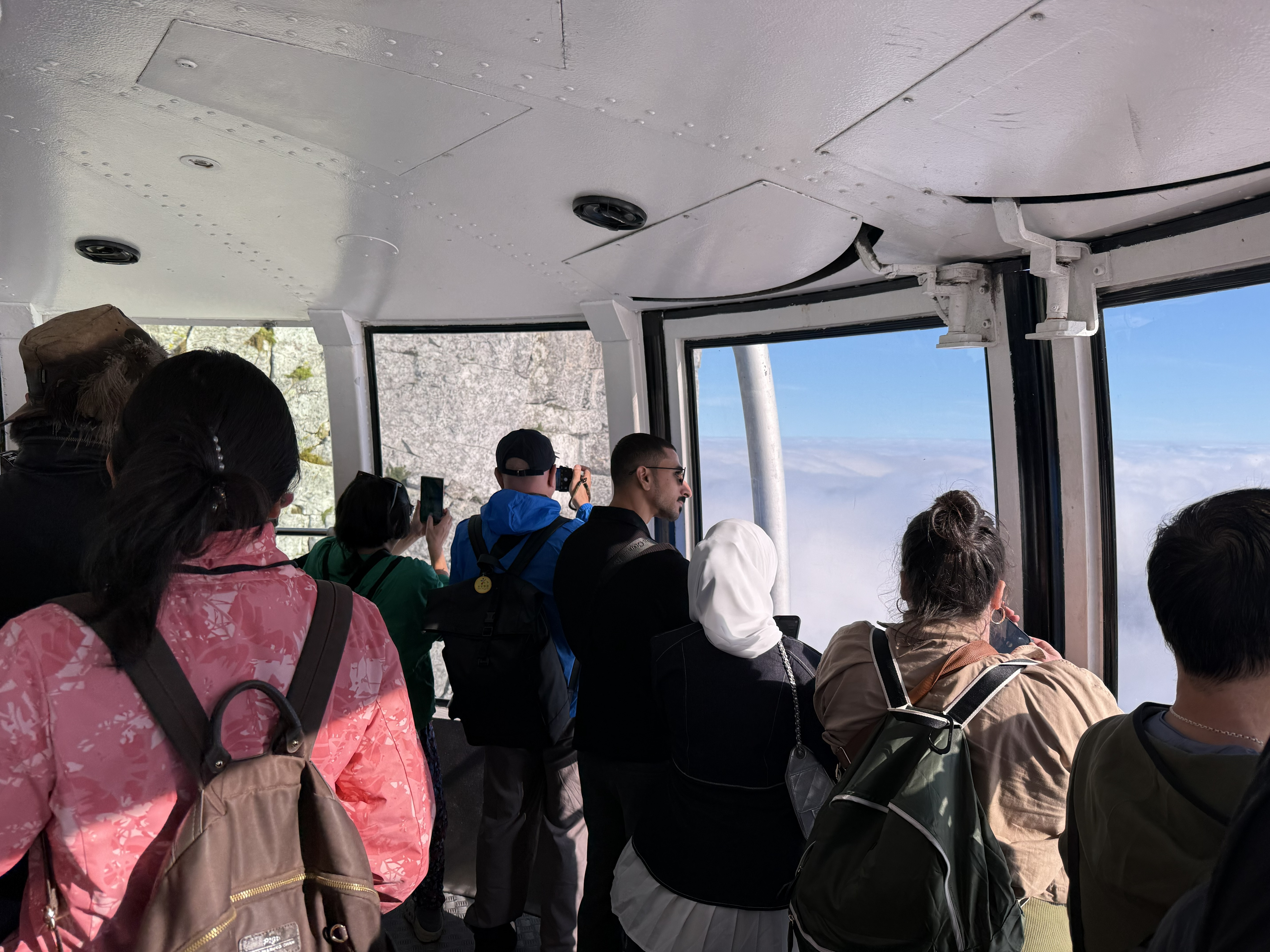 Inside the rotating car, the whole group pressed to the glass.