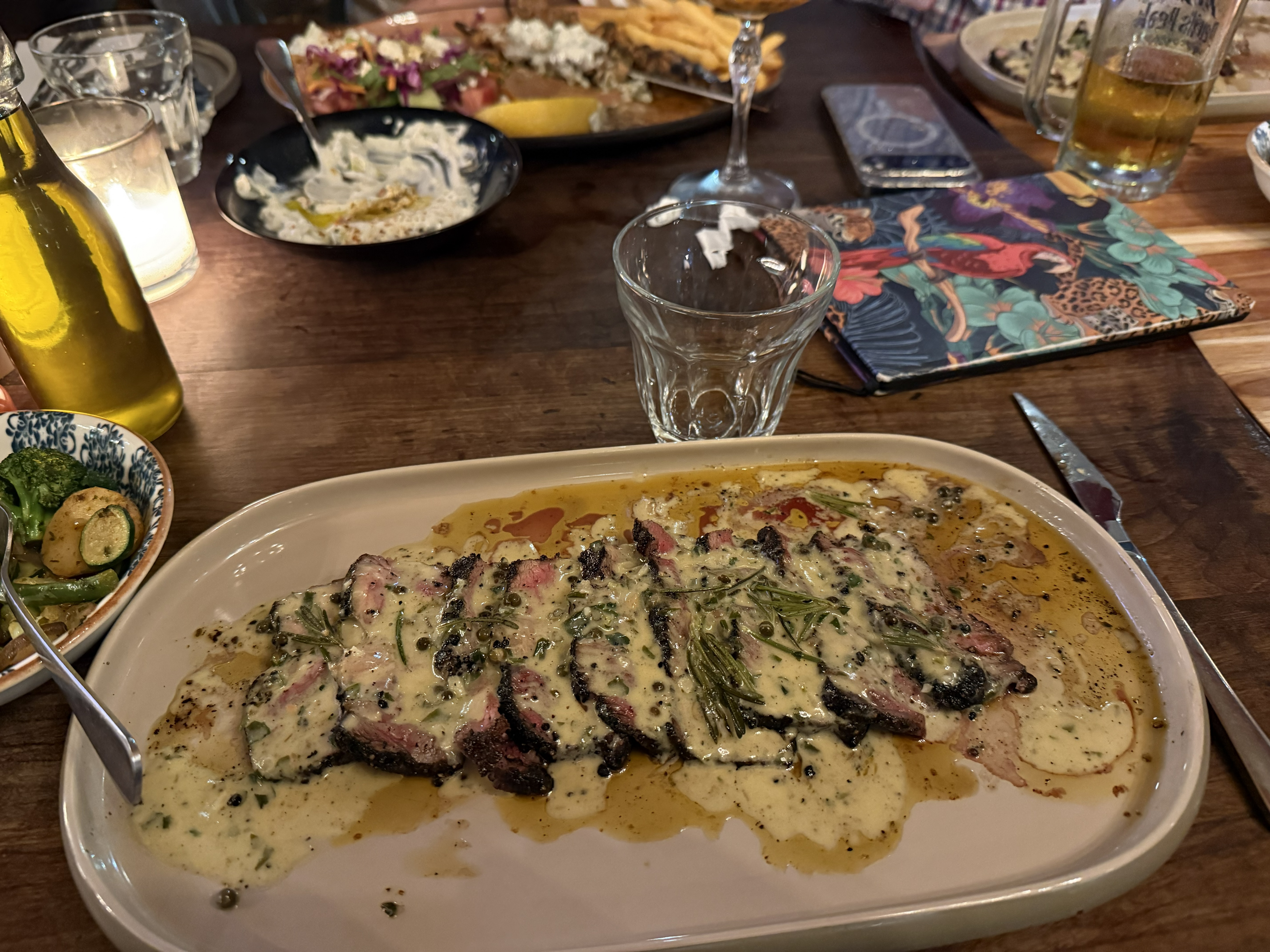 Dinner: a porterhouse roughly the size of the day itself. Somewhere between Robben Island and this plate lies the whole strange privilege of travel — that you can stand inside a na